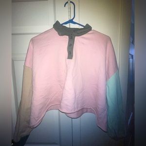 Pink crop top with a green and brown long sleeve.